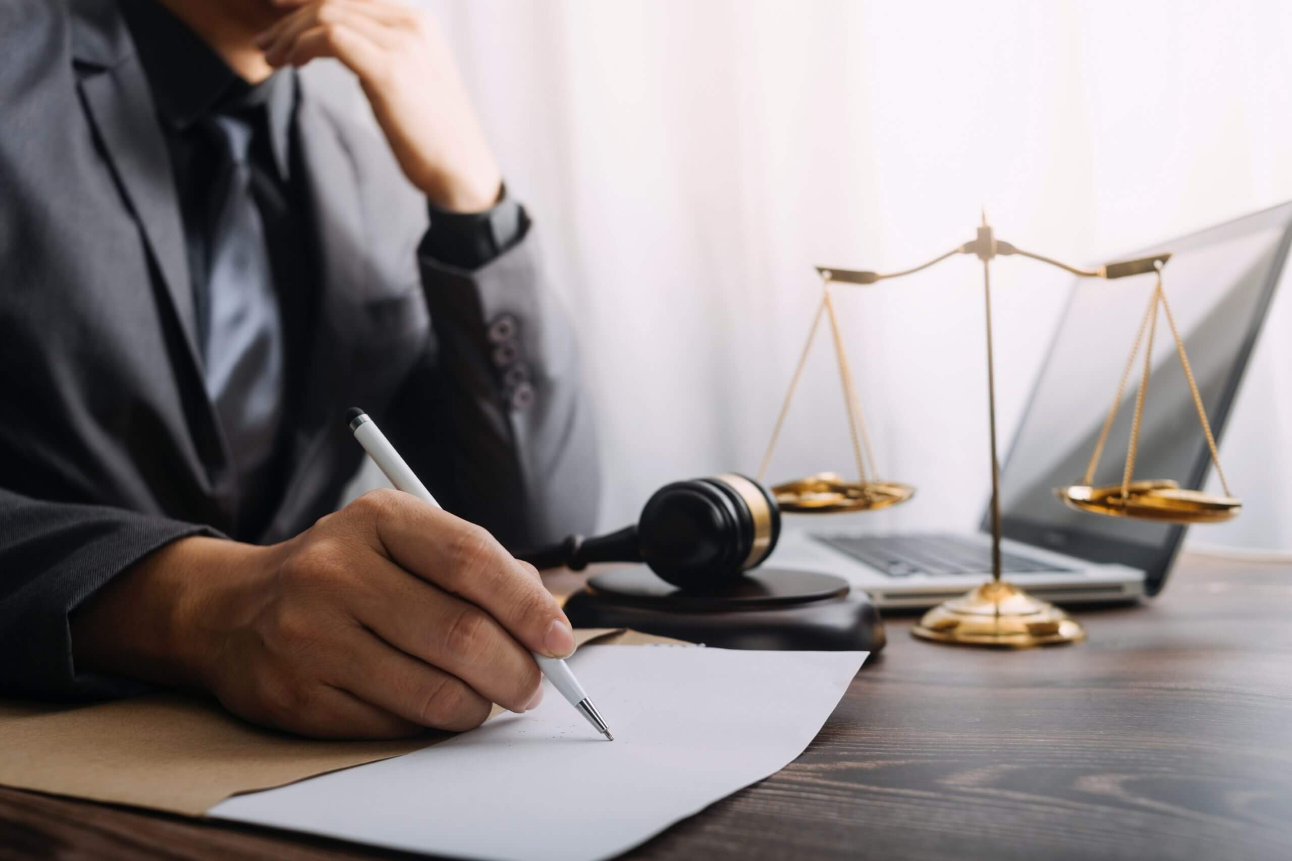 Photo of a Lawyer Writing on Paper
