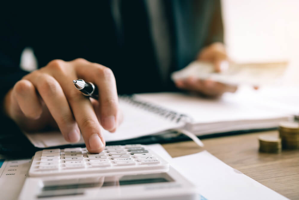 Photo of a Man Calculating Costs