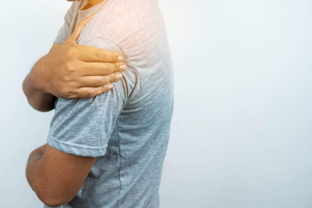 Man with pain in shoulder Man with pain in shoulder and upper arm