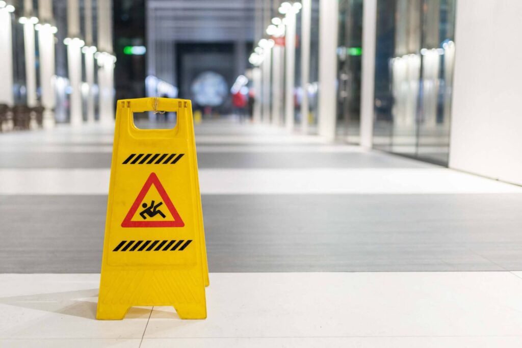 Slippery sign on wet floor Slippery sign on wet floor in office building