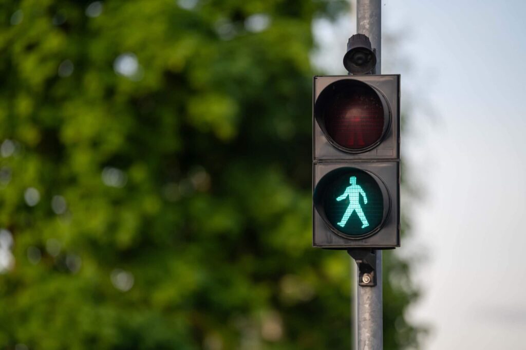 Illuminated green pedestrian signal Illuminated green pedestrian signal, indicating walking