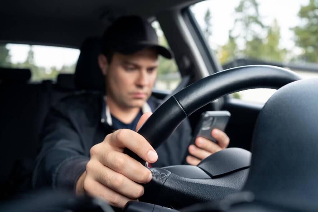 Driving a car and using a phone to text Driving a car and using a phone to text