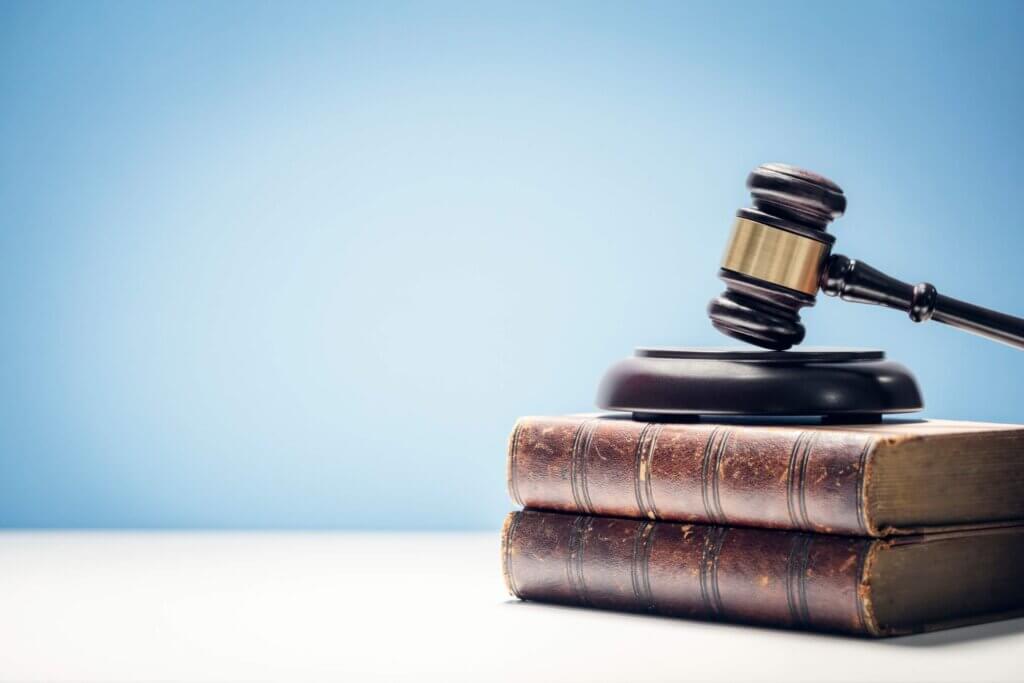 Judge's gavel and law books in courtroom Judge's gavel and law books in courtroom