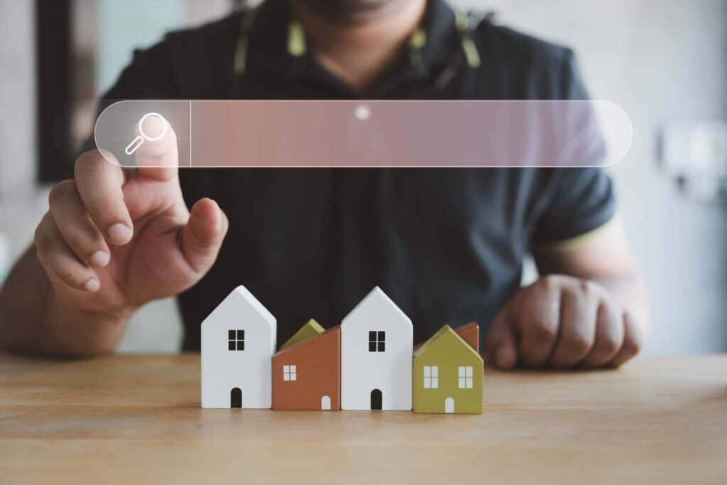 Understanding home insurance policies A man's hand touching a magnifying glass icon looking for home information